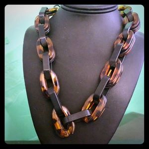Tortoiseshell necklace made out of thick plastic.